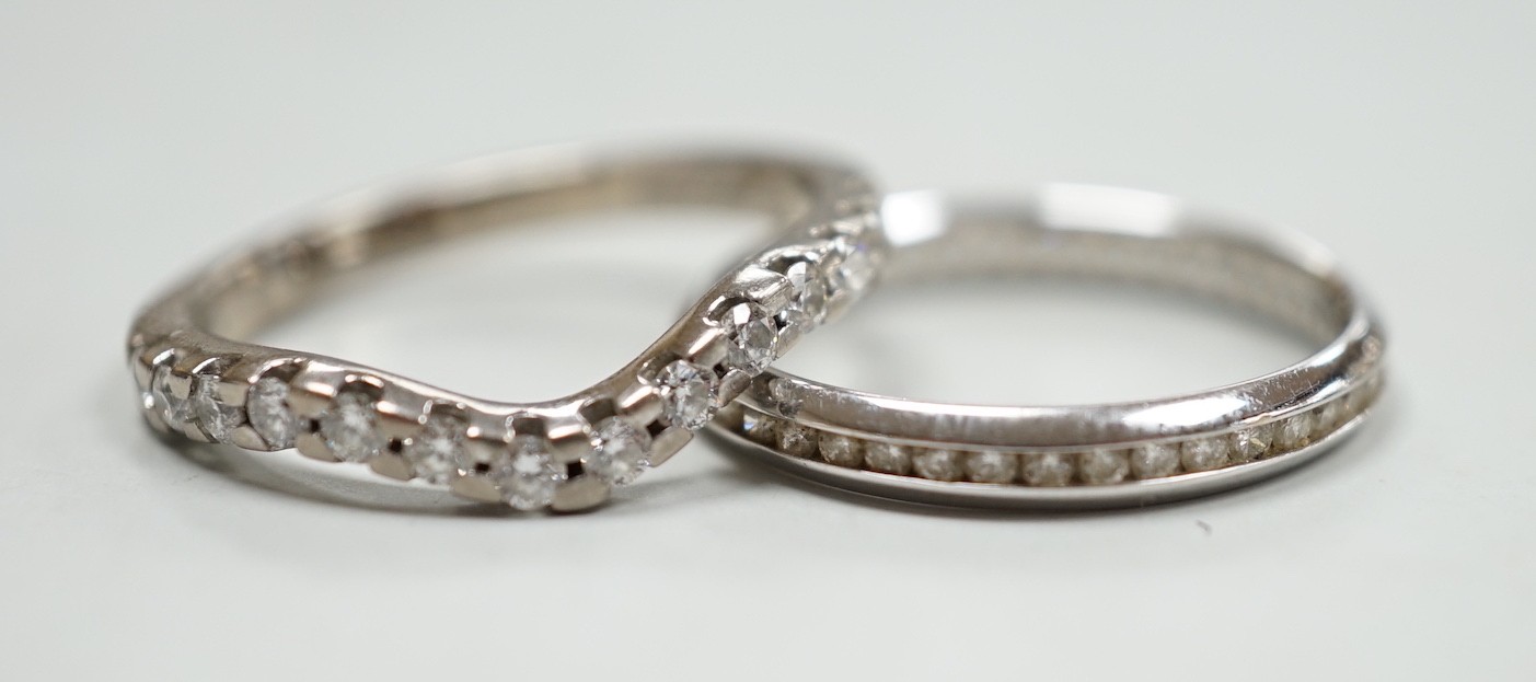 A modern 18ct white gold and diamond chip set full eternity ring, size O and a modern 18ct white gold and fourteen stone diamond chip set shaped half eternity ring, size O, gross weight 5.7 grams.